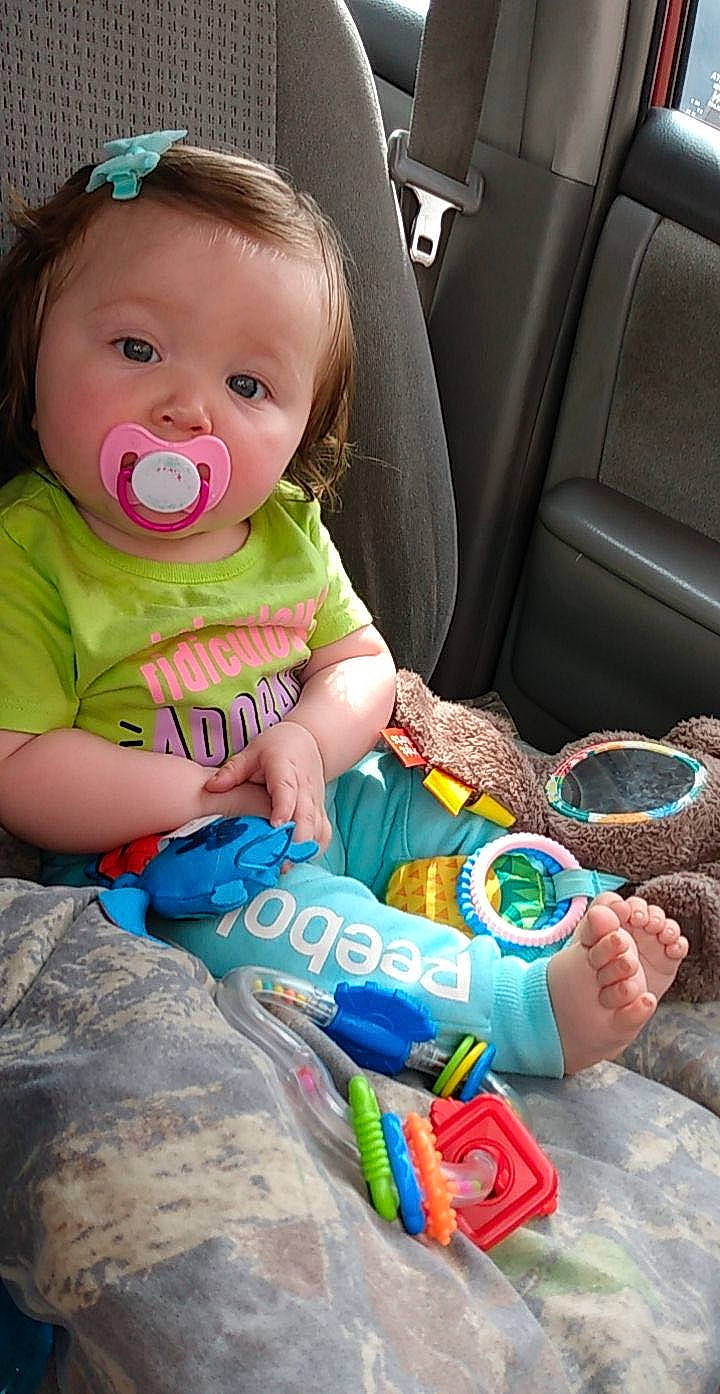 Oakley is registered to the contest to win money with this photo: baby, baby_toddler_clothing, car, car_seat, car_seat_cover, cheek, child, cool, facial_expression, fun, green, hairstyle, happy, head, mouth, person, product, sitting, skin, toddler