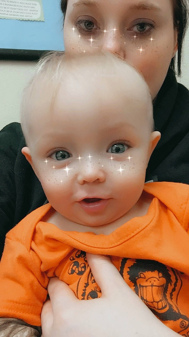 Castiel is registered to the contest to win money with this photo: cheek, close_up, dress, ear, eye, eyebrow, eyelash, forehead, gesture, happy, human_body, iris, lip, mouth, nose, organ, person, skin, toddler, toy