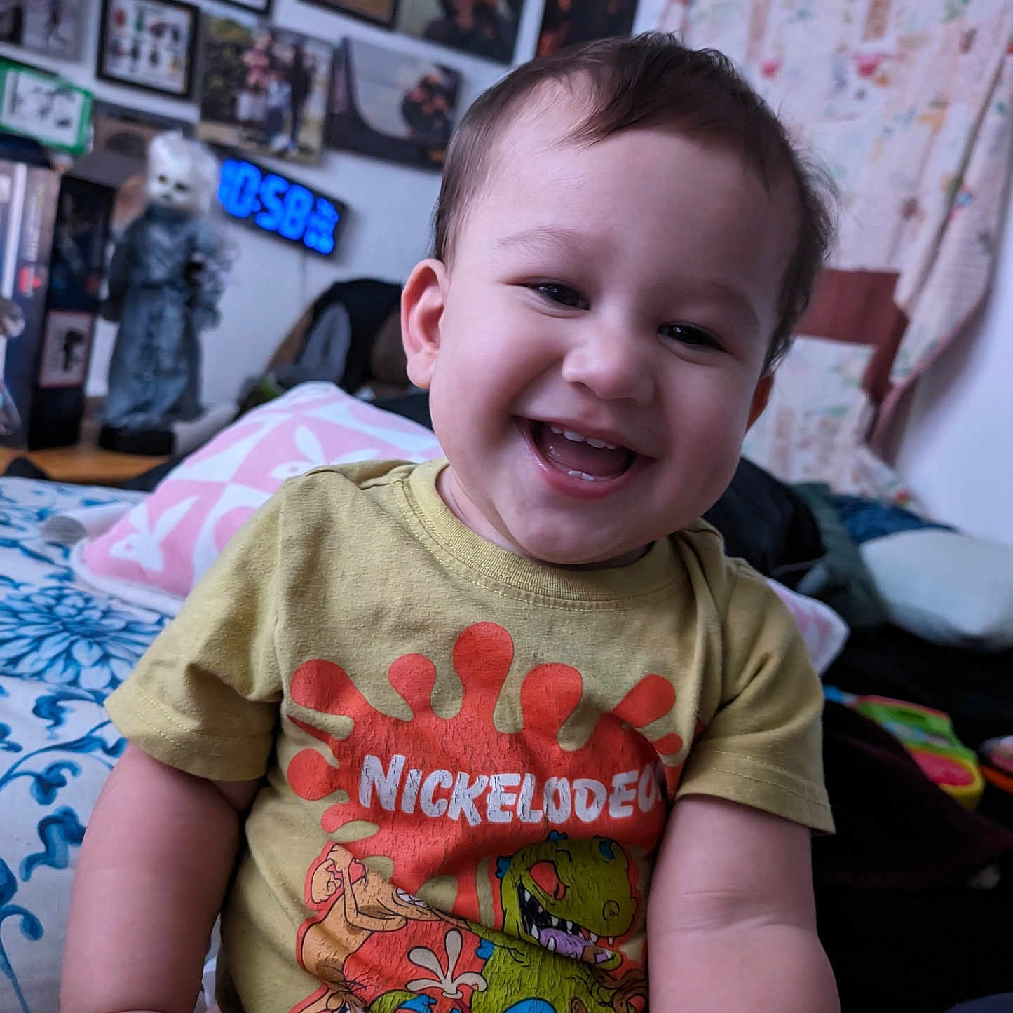 David is registered to the contest to win money with this photo: baby, bed, bedroom, boy, child, clothing, couch, face, furniture, happy, head, indoors, laughing, male, person, photography, portrait, room, smile, t_shirt