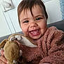 toddler, child, smiling, happy, plush_toy, bunny, stuffed_animal, indoor, cozy, cute, person, face, clothing, toy, young_child, joyful, soft_texture, warm_colors, closeup, portrait