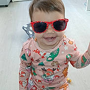Djèlyssa participe au concours pour gagner de l'argent avec cette photo : toddler, child, sunglasses, pajamas, holiday, christmas, candy_cane, reindeer, floor, bedroom, bed, toy, smile, happy, indoor, person, clothing, light, wooden_floor, cute