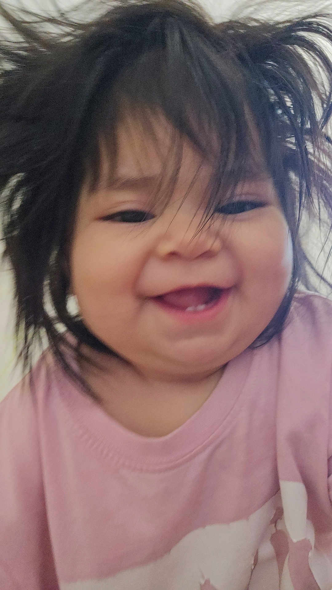 Laurae is registered to the contest to win money with this photo: baby, child, smiling, happy, face, hair, pink_shirt, toddler, portrait, cute, indoors, childhood, joy, expression, young, person, closeup, funny_hair, teeth, playful