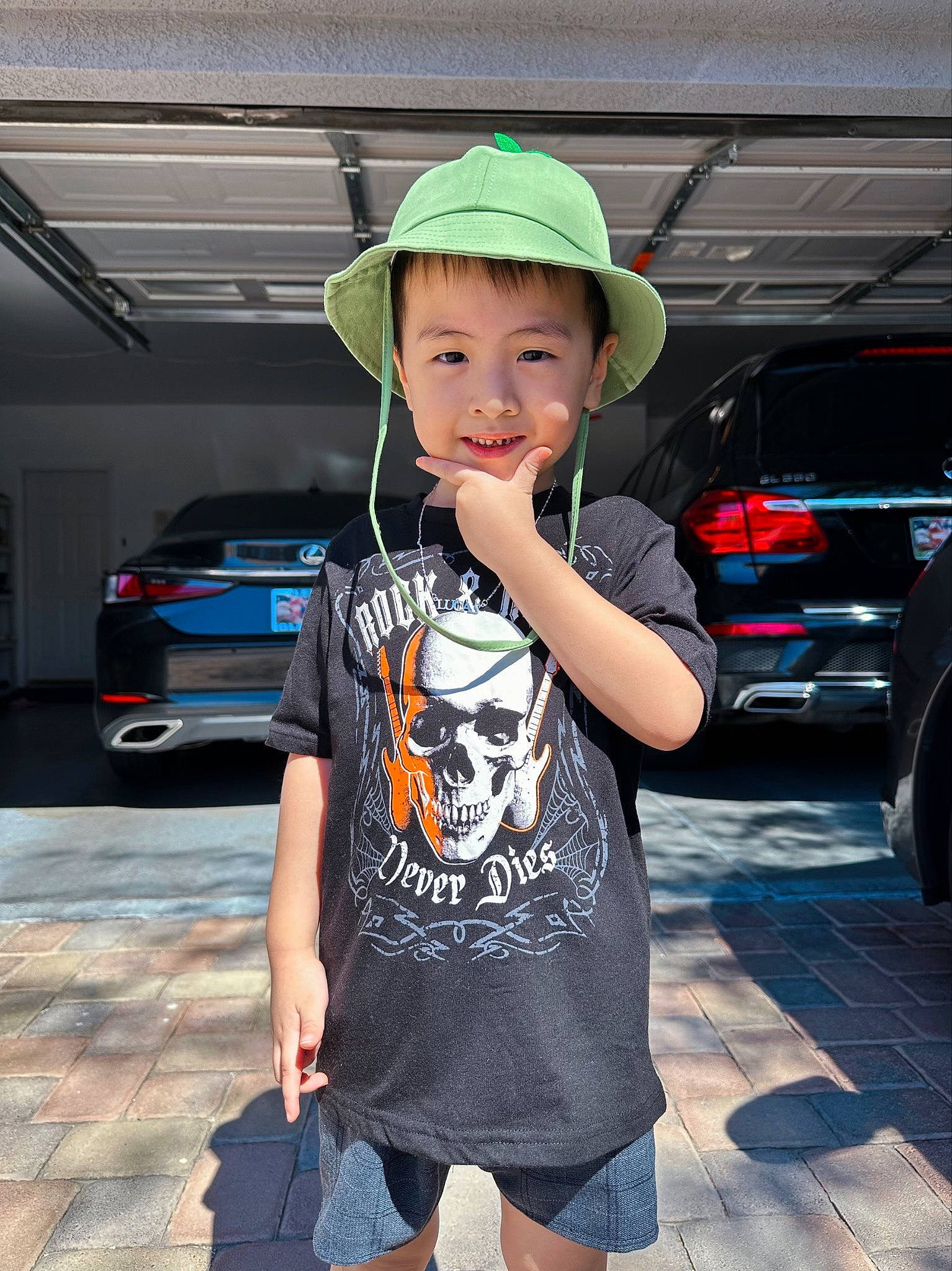 Lucas is registered to the contest to win money with this photo: automotive_design, automotive_exterior, automotive_lighting, automotive_tire, baseball_cap, bumper, cap, car, electric_blue, family_car, hat, motor_vehicle, parking, person, personal_luxury_car, sleeve, t_shirt, tire, toddler, vehicle