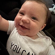 Maverick joined the competition — help win amazing prizes! baby, smiling, close_up, infant, white_shirt, text_on_clothing, happy, face, child, young, cute, portrait, indoors, person, skin, eyes, mouth, hair, expression, toddler