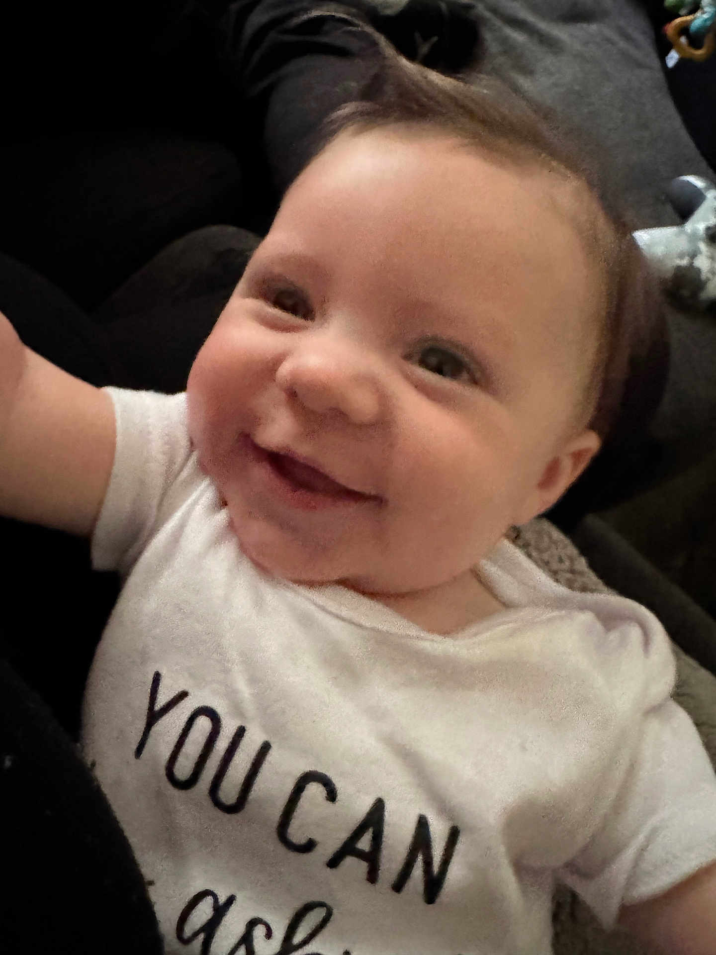 Maverick joined the competition — help win amazing prizes! baby, smiling, close_up, infant, white_shirt, text_on_clothing, happy, face, child, young, cute, portrait, indoors, person, skin, eyes, mouth, hair, expression, toddler