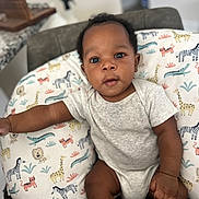 Nolan is registered to the contest to win money with this photo: baby, beanbag, blackhair, clothing, crawling, cushion, face, furniture, hair, happy, head, homedecor, person, photography, pillow, portrait, sitting, sleeve, smile, t_shirt