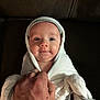 Natalia is registered to the contest to win money with this photo: baby, blanket, hand, face, person, infant, cozy, wrapped, soft, white, gray_trim, cute, looking_up, indoor, portrait, newborn, skin, expression, comfort, toddler