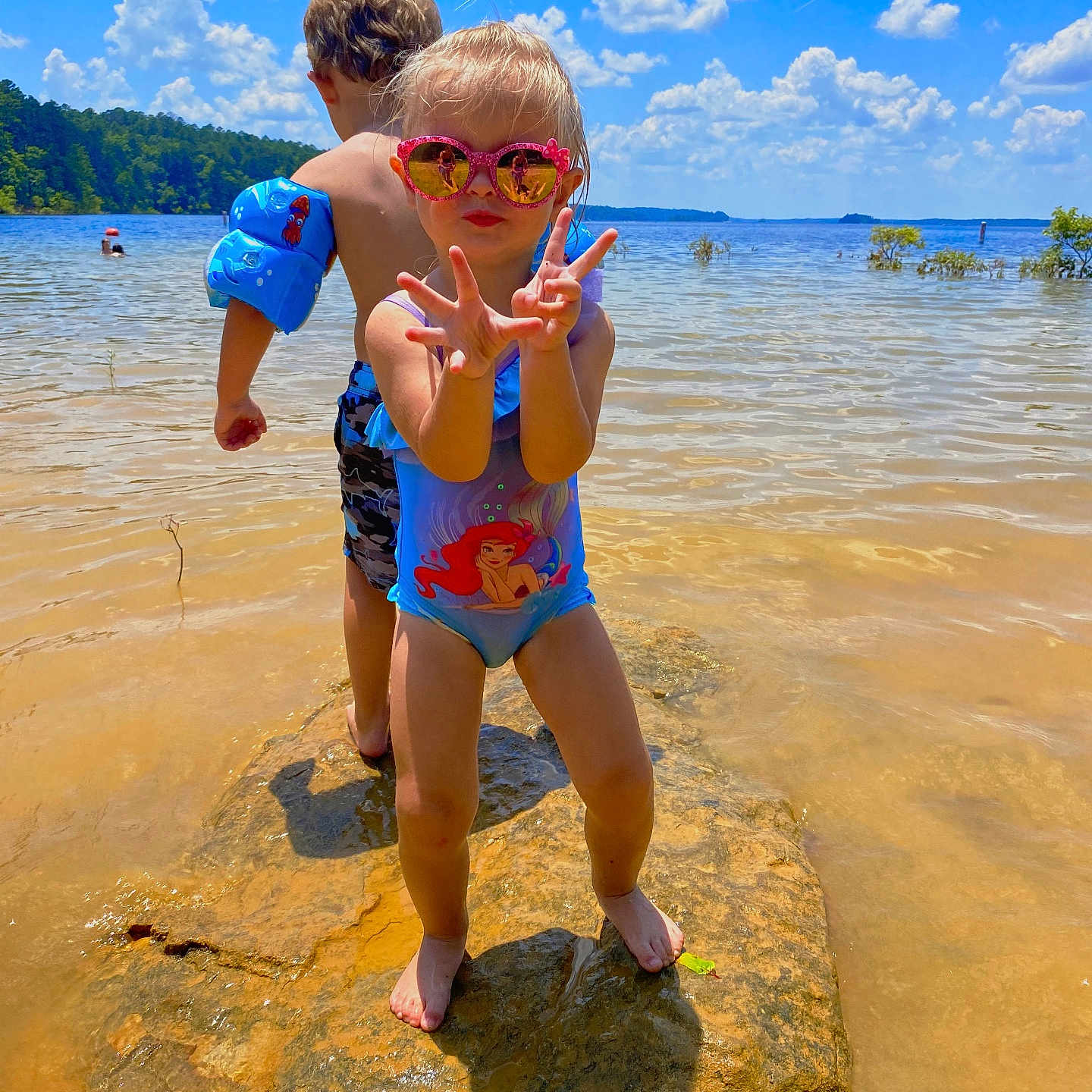Presley is registered to the contest to win money with this photo: accessories, beach, boy, clothing, coast, face, head, nature, outdoors, person, photography, portrait, rock, sea, shoreline, shorts, summer, sunglasses, swimwear, water