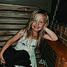 Presley is registered to the contest to win money with this photo: child, girl, smiling, portrait, dog, black_dog, pet, animal, outdoor, rustic, wooden_bench, brick, chain, long_hair, blonde_hair, dress, sitting, cuddling, happy, backyard