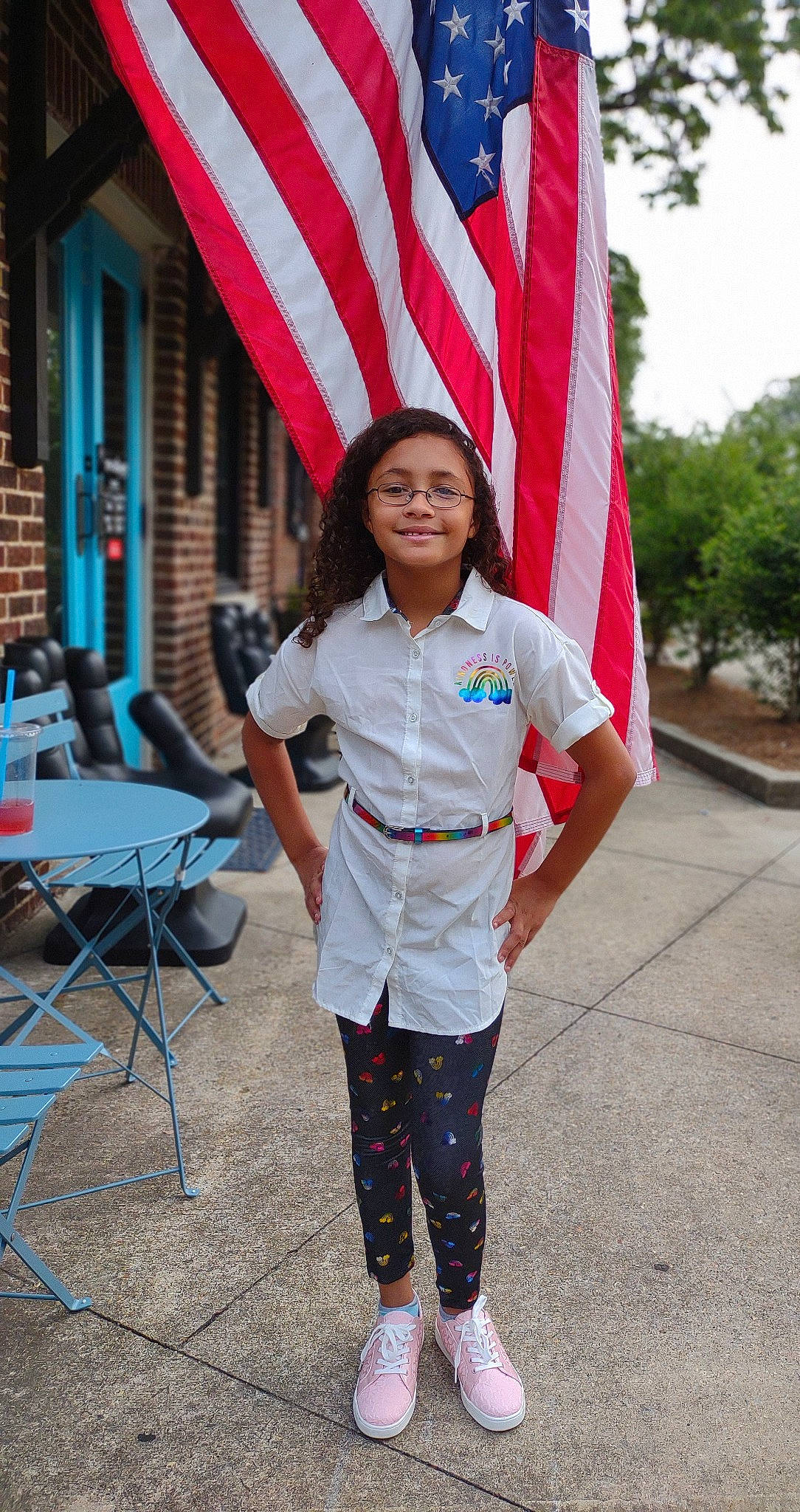 Parris is registered to the contest to win money with this photo: blue, cap, chair, event, flag, flag_day_usa, flag_of_the_united_states, happy, joy, leisure, pattern, people, person, pink, recreation, red, sleeve, smile, street_fashion, table