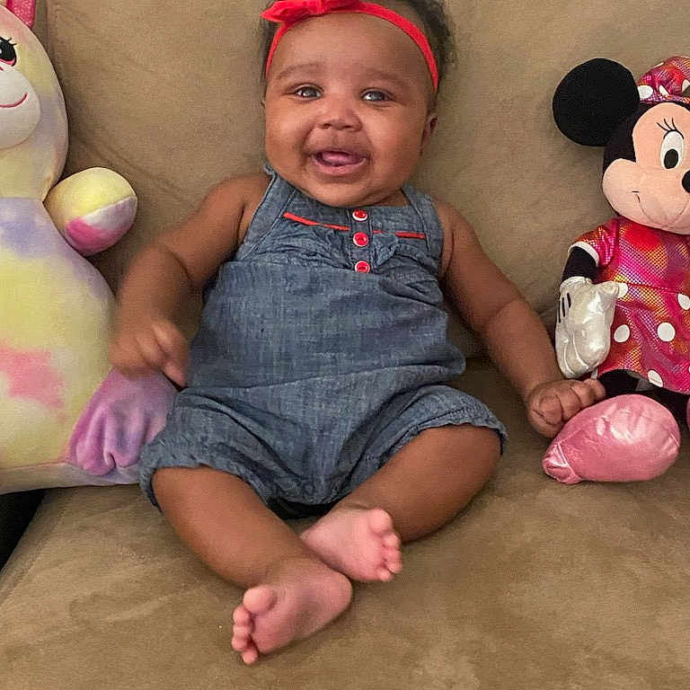 Kaliyah joined the competition — help win amazing prizes! accessories, baby, bag, clothing, couch, cushion, dress, face, furniture, handbag, happy, head, homedecor, pants, person, photography, portrait, sitting, smile, toy