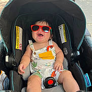 Abel joined the competition — help win amazing prizes! baby, child, stroller, sunglasses, smiling, outdoor, sunny, romper, infant, happy, seatbelt, seat, person, cute, summer, walking, sidewalk, shade, playful, accessory