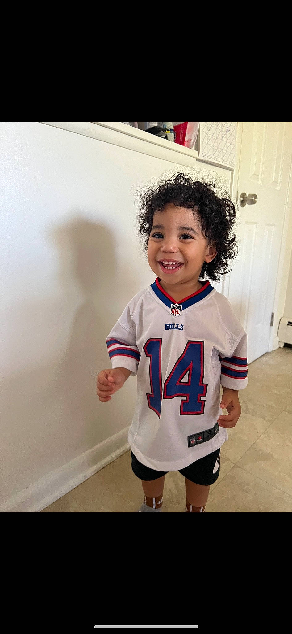 Karter is registered to the contest to win money with this photo: arm, chin, cool, door, fashion_design, flash_photography, floor, flooring, happy, human_body, iris, jersey, joy, person, shorts, skin, sleeve, smile, sports_uniform, sportswear