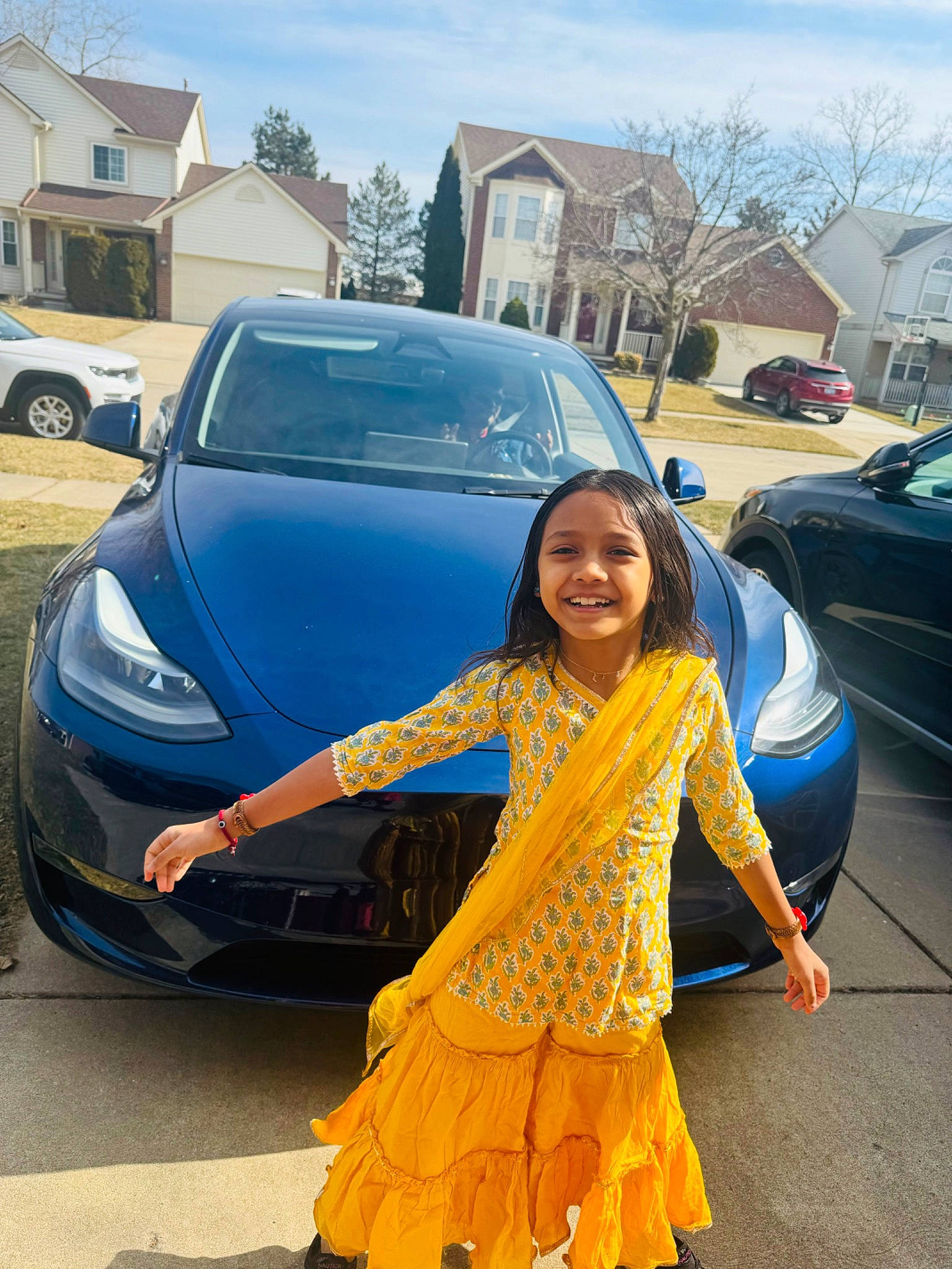 Avishka is registered to the contest to win money with this photo: asphalt, automotive_design, automotive_exterior, automotive_lighting, automotive_wheel_system, bumper, car, electric_blue, hood, joy, land_vehicle, motor_vehicle, person, personal_luxury_car, road, sky, smile, tire, tree, vehicle