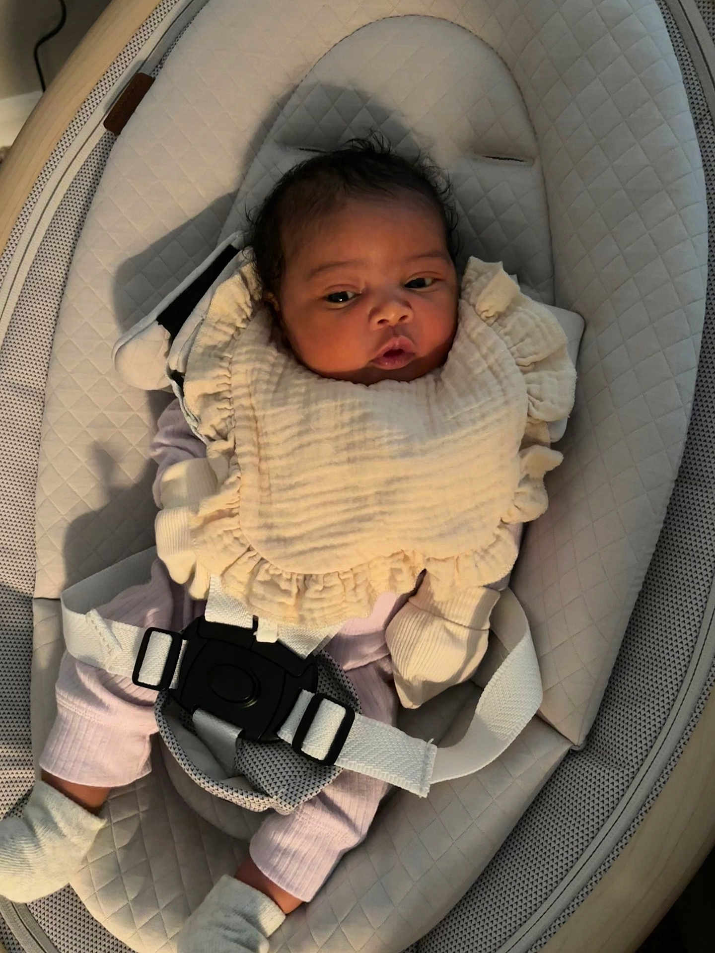 Averyana is registered to the contest to win money with this photo: adorable, baby, baby_seat, bib, buckle, clothing, comfort, cushion, cute, expression, face, indoor, infant, looking_away, mittens, newborn, person, sitting, soft_lighting, textile