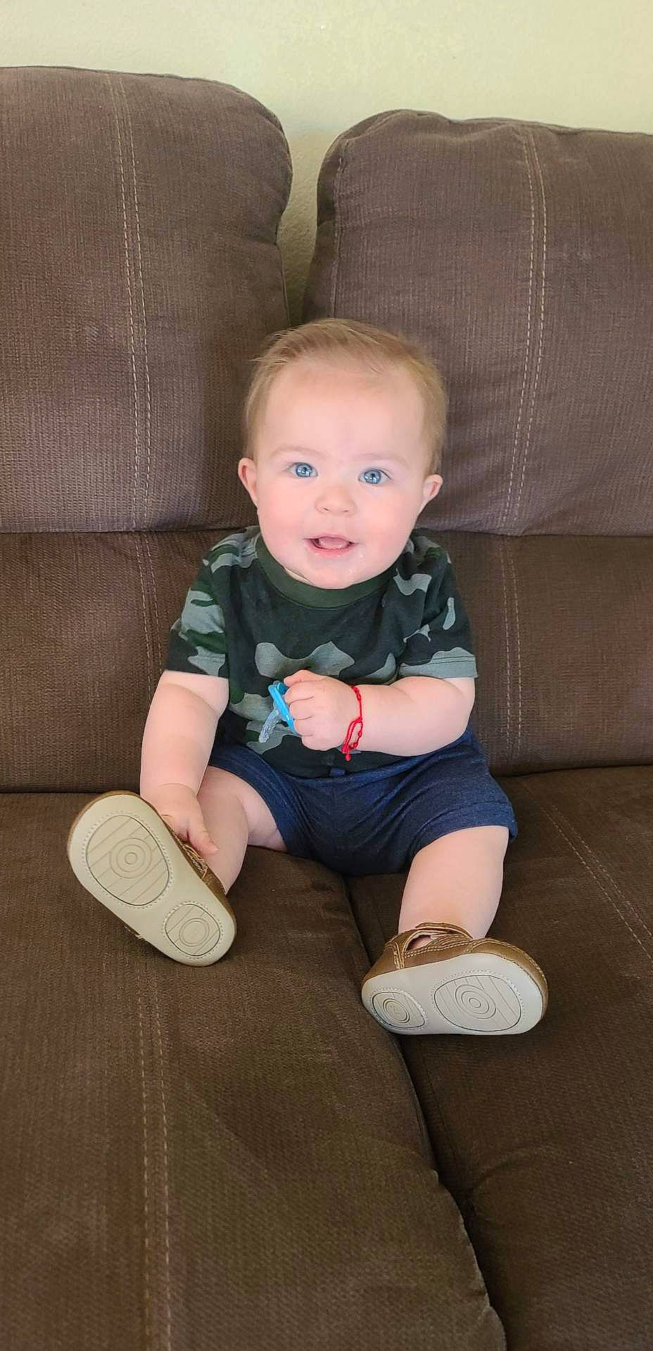 Santiago is registered to the contest to win money with this photo: baby, baby_toddler_clothing, cheek, child, comfort, couch, face, finger, flash_photography, head, knee, person, shoe, skin, sleeve, smile, sneakers, sock, toddler, walking_shoe