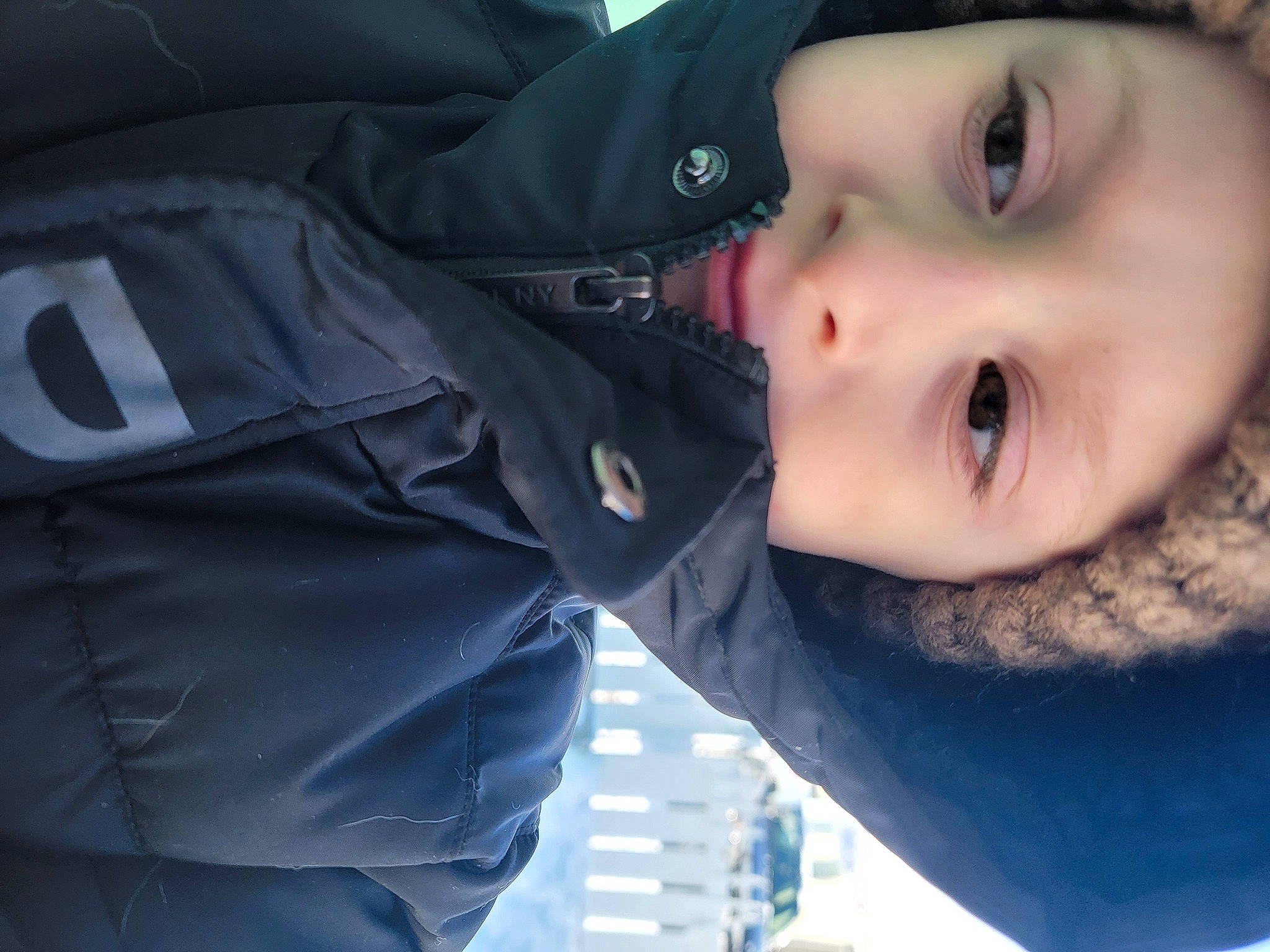 Corbin is registered to the contest to win money with this photo: cheek, cool, electric_blue, eyebrow, eyelash, flash_photography, gesture, happy, jacket, lip, mouth, nose, outerwear, person, skin, sleeve, smile, toddler, tree, windbreaker