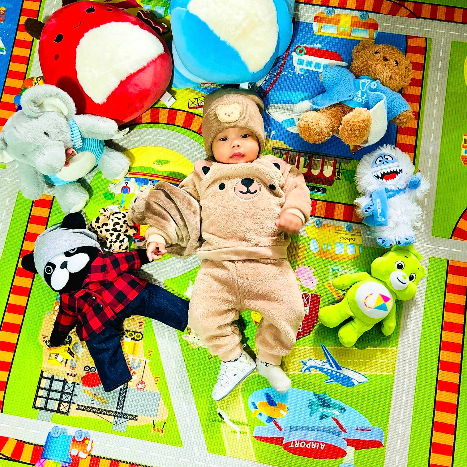 Noyer joined the competition — help win amazing prizes! baby, bear_outfit, child, childhood, colorful, cute, floor, hat, indoor, play_mat, plush_toys, smiling, soft_toys, stuffed_animals, teddy_bear, toy_bear, toy_elephant, toy_frog, toy_raccoon, toy_yeti