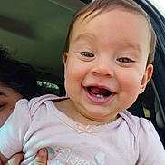 Rylee joined the competition — help win amazing prizes! baby, child, smiling, happy, girl, bow, clothing, pink_shirt, teeth, hand, car_interior, window, sunlight, face, person, portrait, cute, young, sibling, holding