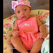 Rhyver is registered to the contest to win money with this photo: baby, infant, child, pink_clothing, headband, bow, cushion, floral_pattern, sofa, portrait, indoors, cute, sitting, hands, feet, expression, face, skin, young, comfortable