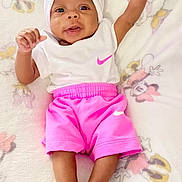 Luna Skye is registered to the contest to win money with this photo: baby, child, infant, smiling, white_headband, pink_shorts, blanket, minnie_mouse, lying_down, happy, cute, small_feet, raised_arm, indoor, clothing, person, portrait, toddler, soft_texture, resting