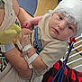 Chester is registered to the contest to win money with this photo: baby, infant, medical_equipment, bandage, electrodes, hospital, child, person, arm, hand, clothing, shirt, blanket, plaid, tattoo, bed, cable, monitoring, care, holding