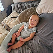 Chester joined the competition — help win amazing prizes! baby, infant, smiling, bed, pillow, blanket, clothing, person, indoor, relaxing, cute, happy, skin, head, face, furniture, room, comfort, resting, lying_down