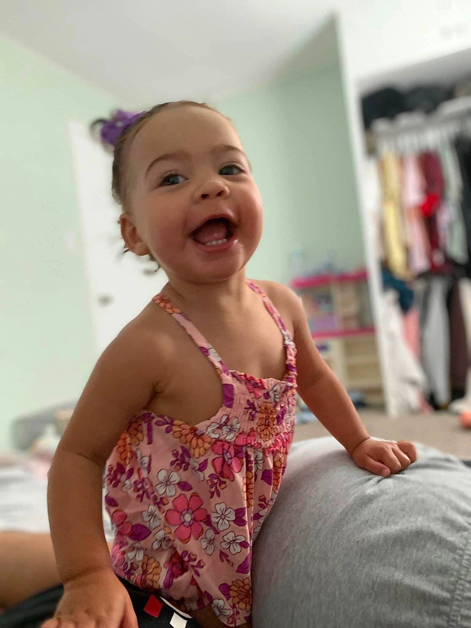 Ariya is registered to the contest to win money with this photo: arm, baby, baby_toddler_clothing, child, comfort, elbow, finger, flooring, fun, happy, human_leg, leisure, pattern, person, room, sitting, sleeve, smile, thigh, thumb
