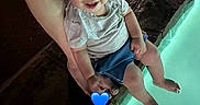 Isaiah is registered to the contest to win money with this photo: toddler, child, adult_hand, pool, water, night, smile, curly_hair, casual_clothing, legs, feet, social_media_interface, emoji, message_box, profile_icon, love_heart, ring, outdoor, person, photograph