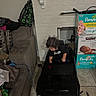Isaiah is registered to the contest to win money with this photo: toddler, toy_car, indoor, child, couch, diaper_boxes, fireplace, curly_hair, black_toy_car, brown_couch, floor_tiles, clothing, person, home, living_room, seat, looking_down, stacked_boxes, casual, child_playing