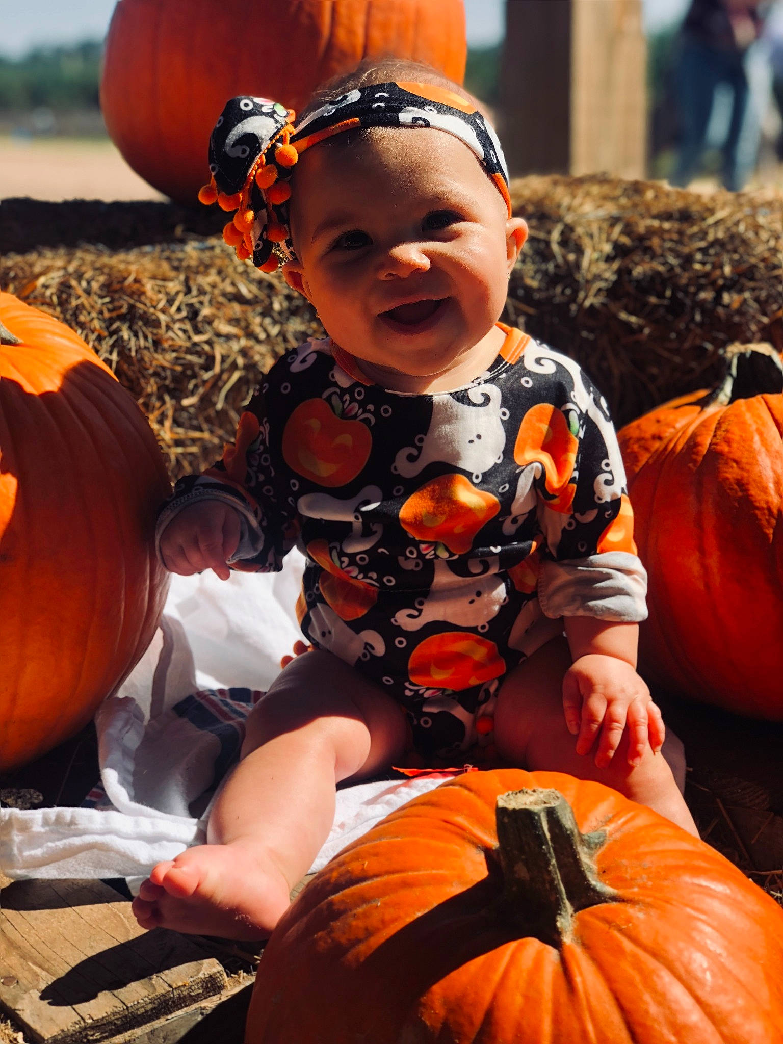 Madyson is registered to the contest to win money with this photo: baby, baby_toddler_clothing, black, calabaza, cucurbita, facial_expression, gourd, happy, joy, natural_foods, orange, people, person, photograph, plant, pumpkin, smile, snapshot, squash, toddler