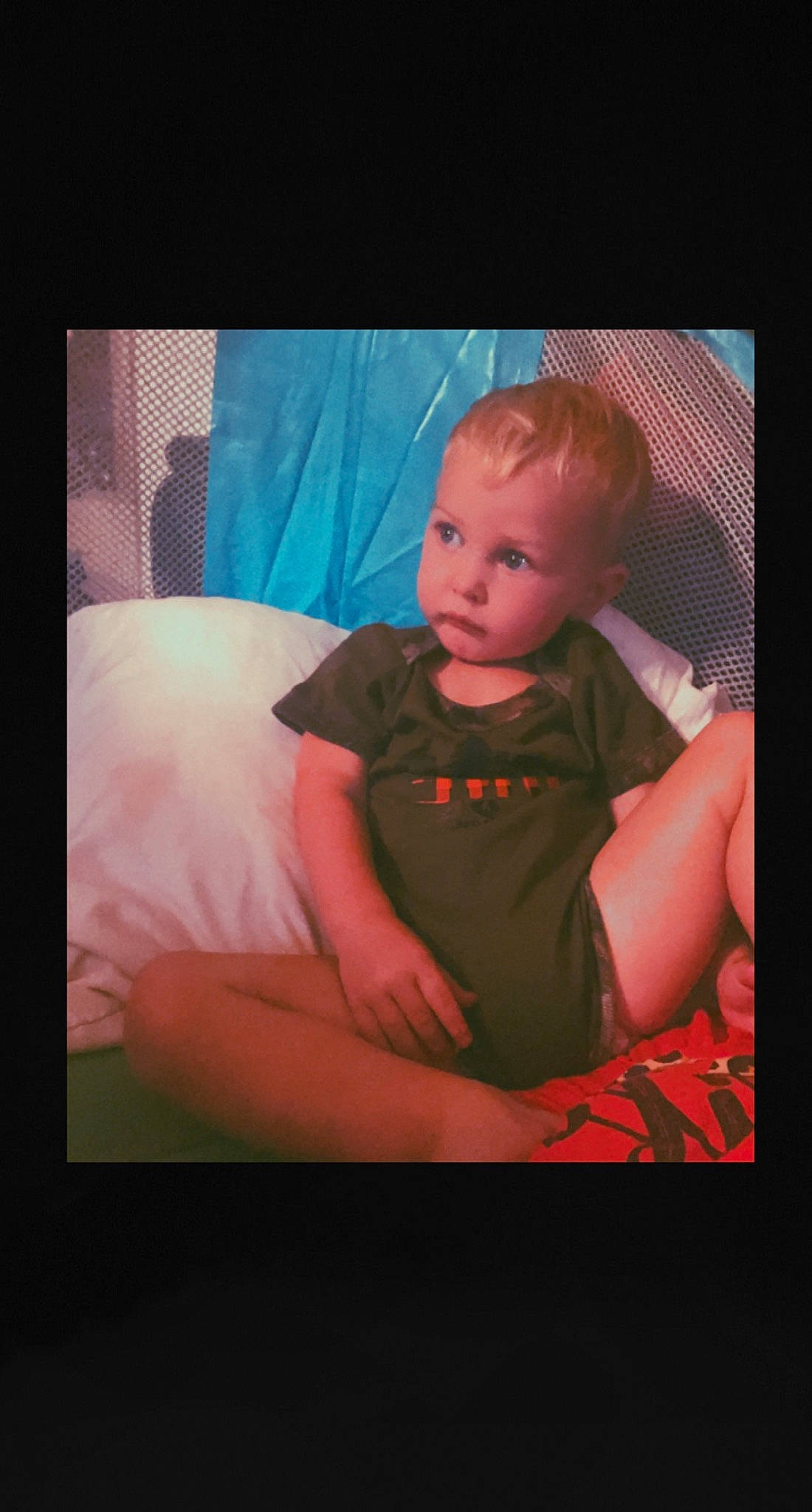 Brentley is registered to the contest to win money with this photo: baby, baby_toddler_clothing, child, comfort, couch, darkness, display_device, electric_blue, flash_photography, fun, magenta, mouth, person, pink, portrait, room, sitting, sleeve, t_shirt, tints_and_shades