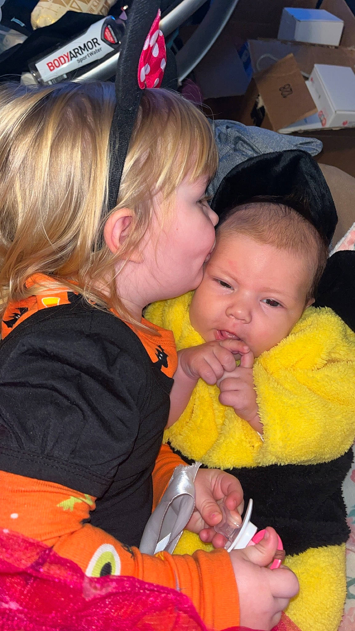 Leoline is registered to the contest to win money with this photo: baby, baby_products, baby_toddler_clothing, cheek, child, event, facial_expression, fun, happy, interaction, iris, lap, mouth, orange, organ, people, person, sharing, sitting, skin