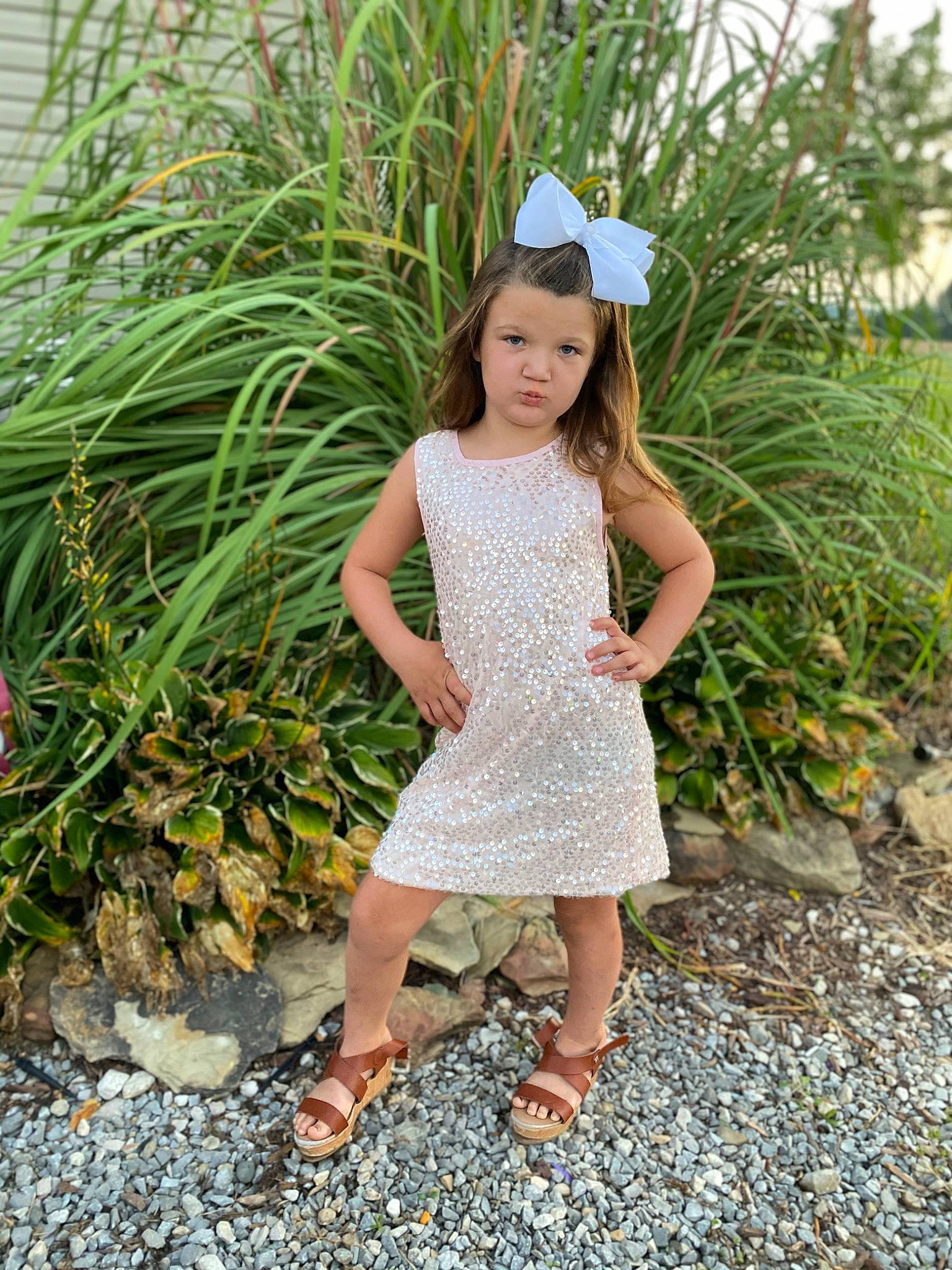 Kenley is registered to the contest to win money with this photo: botany, day_dress, dress, grass, grass_family, happy, human_leg, leaf, long_hair, one_piece_garment, pattern, people_in_nature, person, plant, shrub, street_fashion, summer, terrestrial_plant, toddler, tree