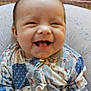 baby, smile, happy, infant, clothing, pattern, pillow, blanket, indoors, cute, face, child, portrait, sitting, young, cozy, human, skin, cute_expression, warm