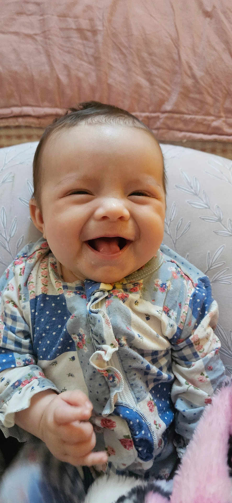 Maisie is registered to the contest to win money with this photo: baby, smile, happy, infant, clothing, pattern, pillow, blanket, indoors, cute, face, child, portrait, sitting, young, cozy, human, skin, cute_expression, warm