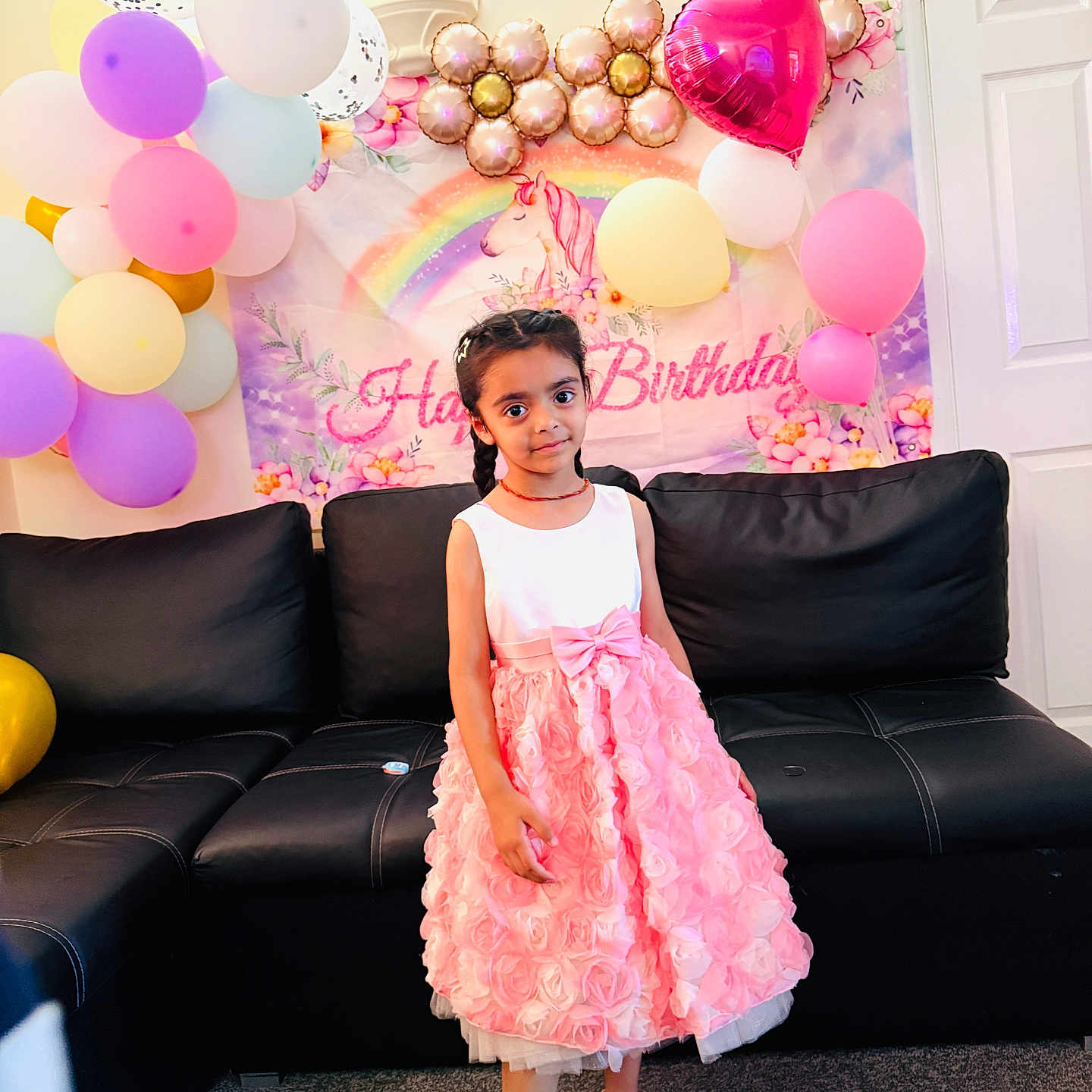 Manreet joined the competition — help win amazing prizes! balloons, birthday, carpet, celebration, child, couch, decorations, door, dress, footwear, girl, hair, indoors, party, pink, rainbow, smile, unicorn, wall, white