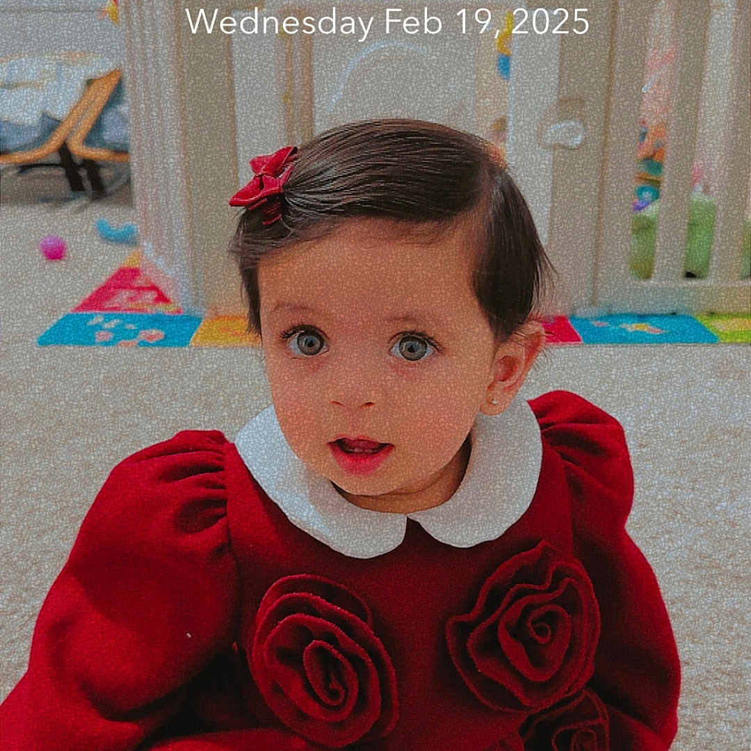 Filza is registered to the contest to win money with this photo: accessories, baby, clothing, costume, crib, dress, face, flower, furniture, head, indoors, infantbed, knitwear, person, photography, plant, portrait, rose, sweater, toy