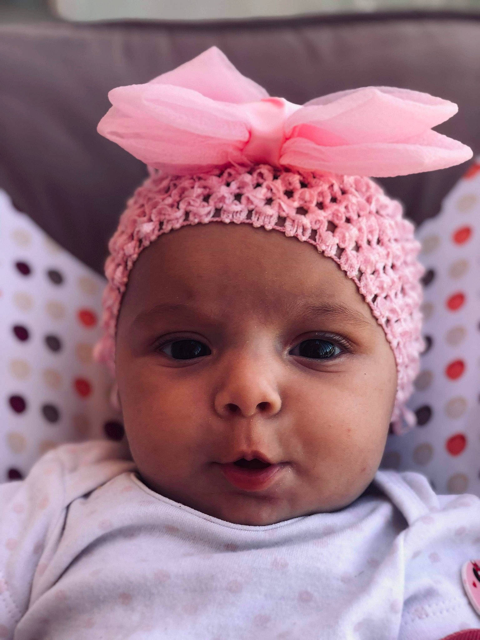 Naëlle participe au concours pour gagner de l'argent avec cette photo : baby, bonnet, cheek, child, clothing, ear, face, fashion_accessory, hair_accessory, head, headgear, knit_cap, lip, person, pink, smile, toddler