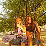Aliya a rejoint le concours — aidez-le/la à gagner de superbes lots ! child, children, tire_swing, playground, sand, tree, sunlight, outdoor, park, barefoot, play, summer, happy, braids, casual_clothing, nature, leaves, rope, fun, friends