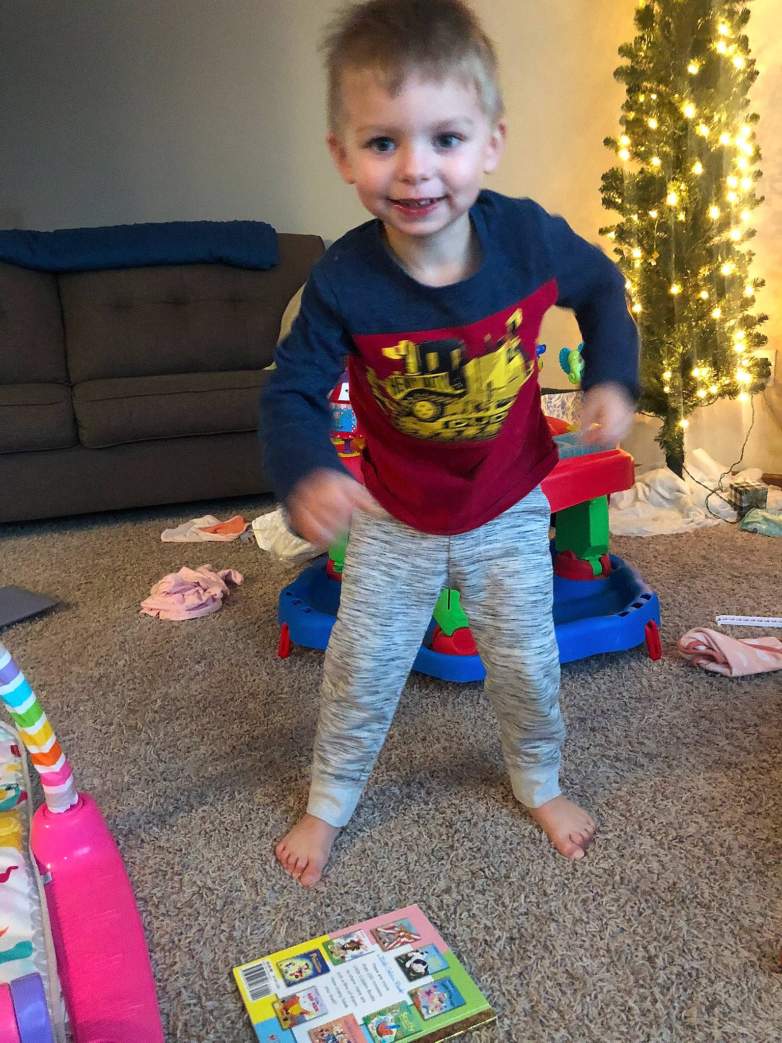 Brooks joined the competition — help win amazing prizes! baby_toddler_clothing, child, christmas_tree, event, flooring, fun, happy, head, holiday, joy, pajamas, pattern, person, plastic_bottle, play, sitting, sleeve, smile, t_shirt, toddler