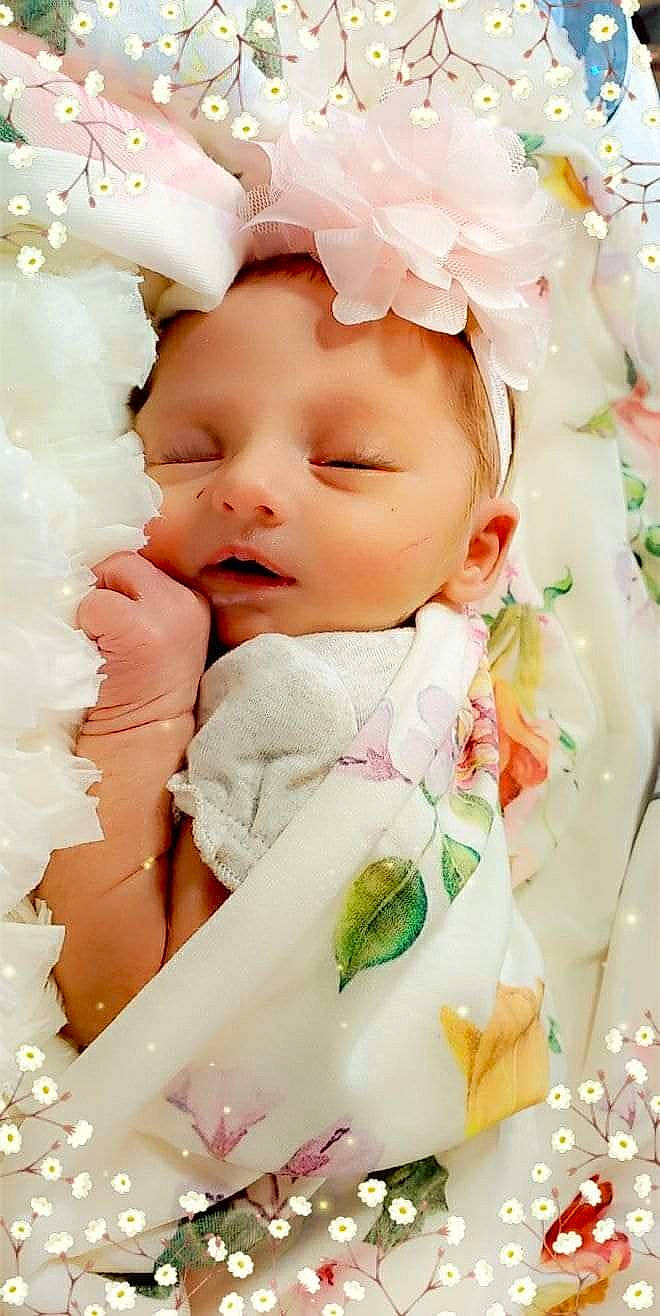 Delaney is registered to the contest to win money with this photo: baby, baby_sleeping, cheek, child, hair_accessory, head, headwear, person, petal, pink, skin, toddler