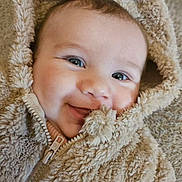Madeva participe au concours pour gagner de l'argent avec cette photo : baby, smiling, face, hood, jacket, fluffy, closeup, portrait, child, cute, warm, soft, apparel, zipped, infant, happy, person, skin, eyes, texture