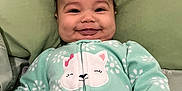 Nevaeh is registered to the contest to win money with this photo: baby, infant, smile, onesie, mint_green, cat_design, pillow, sleepwear, cute, happy, child, face, hand, lying_down, soft_texture, cozy, indoors, portrait, young_child, apparel