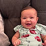 Nevaeh is registered to the contest to win money with this photo: baby, smile, happy, infant, child, couch, clothing, football, pattern, sitting, cute, portrait, indoor, person, young, face, joy, comfort, baby_girl, seated
