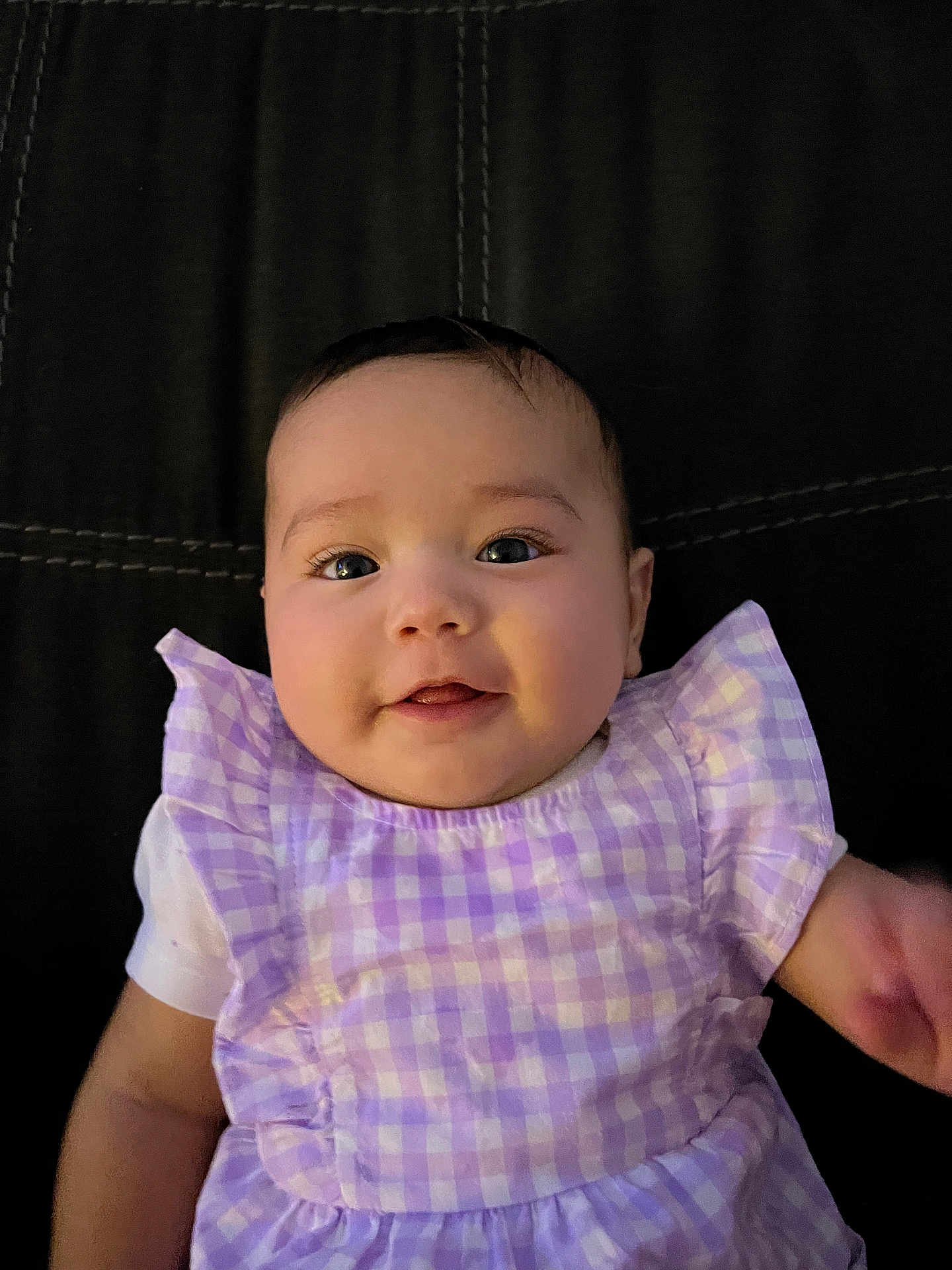 Nevaeh joined the competition — help win amazing prizes! baby, infant, child, smile, face, eyes, dress, clothing, purple, checkered, pattern, sitting, portrait, person, cute, happy, skin, head, indoors, leather
