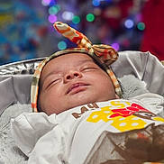 Amaya joined the competition — help win amazing prizes! baby, blanket, bokeh, child, closeup, colorful_lights, cozy, cute, giraffe_print, headband, indoors, infant, newborn, peaceful, portrait, resting, sleeping, soft_texture, warm, white_shirt