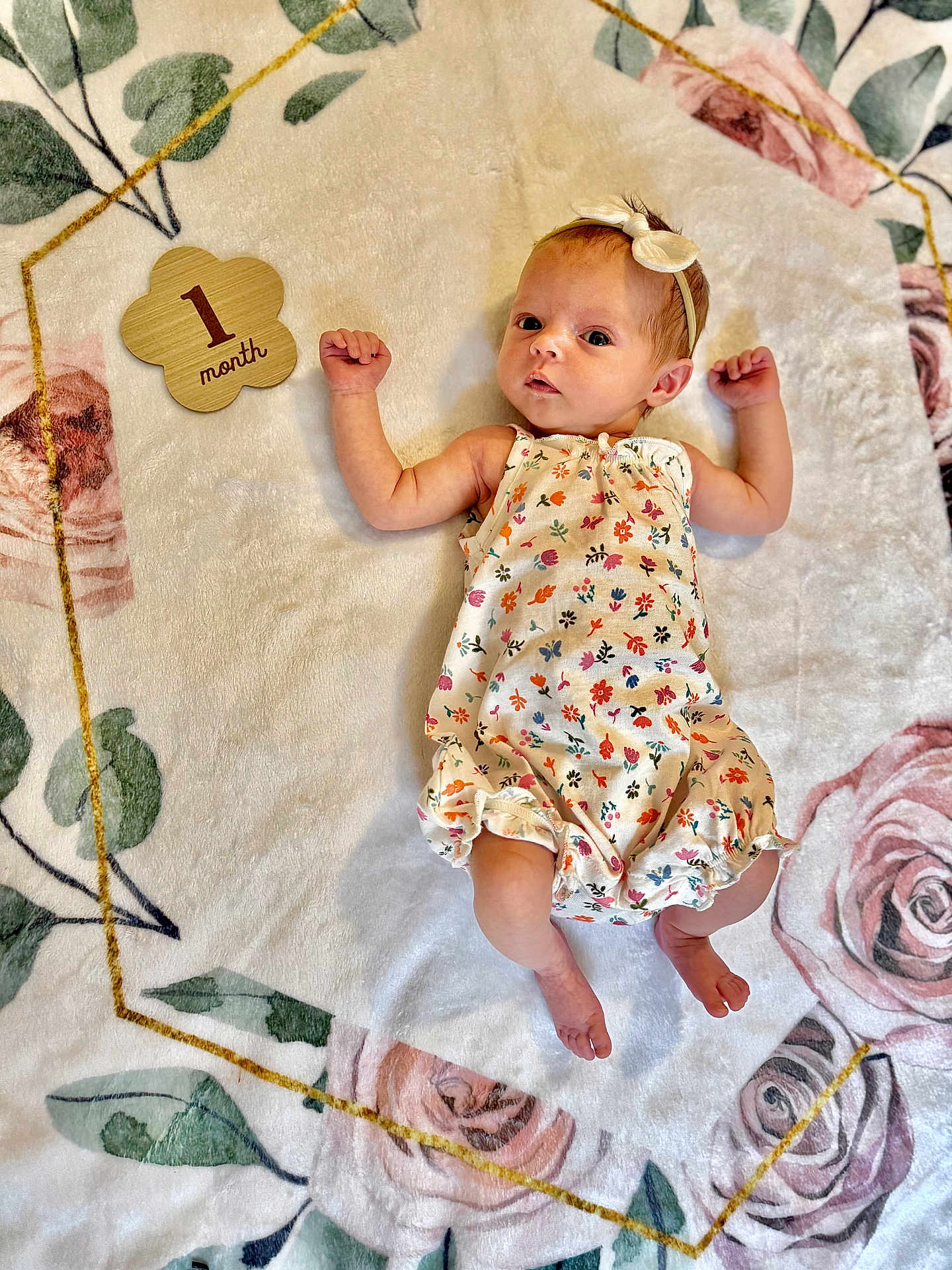 Emery joined the competition — help win amazing prizes! baby, infant, one_month, floral_blanket, headband, cute_outfit, lying_down, raised_arms, soft_texture, portrait, newborn, child, small_feet, sleepwear, decorative_blanket, peaceful, indoors, light_skin, curious_expression, baby_girl
