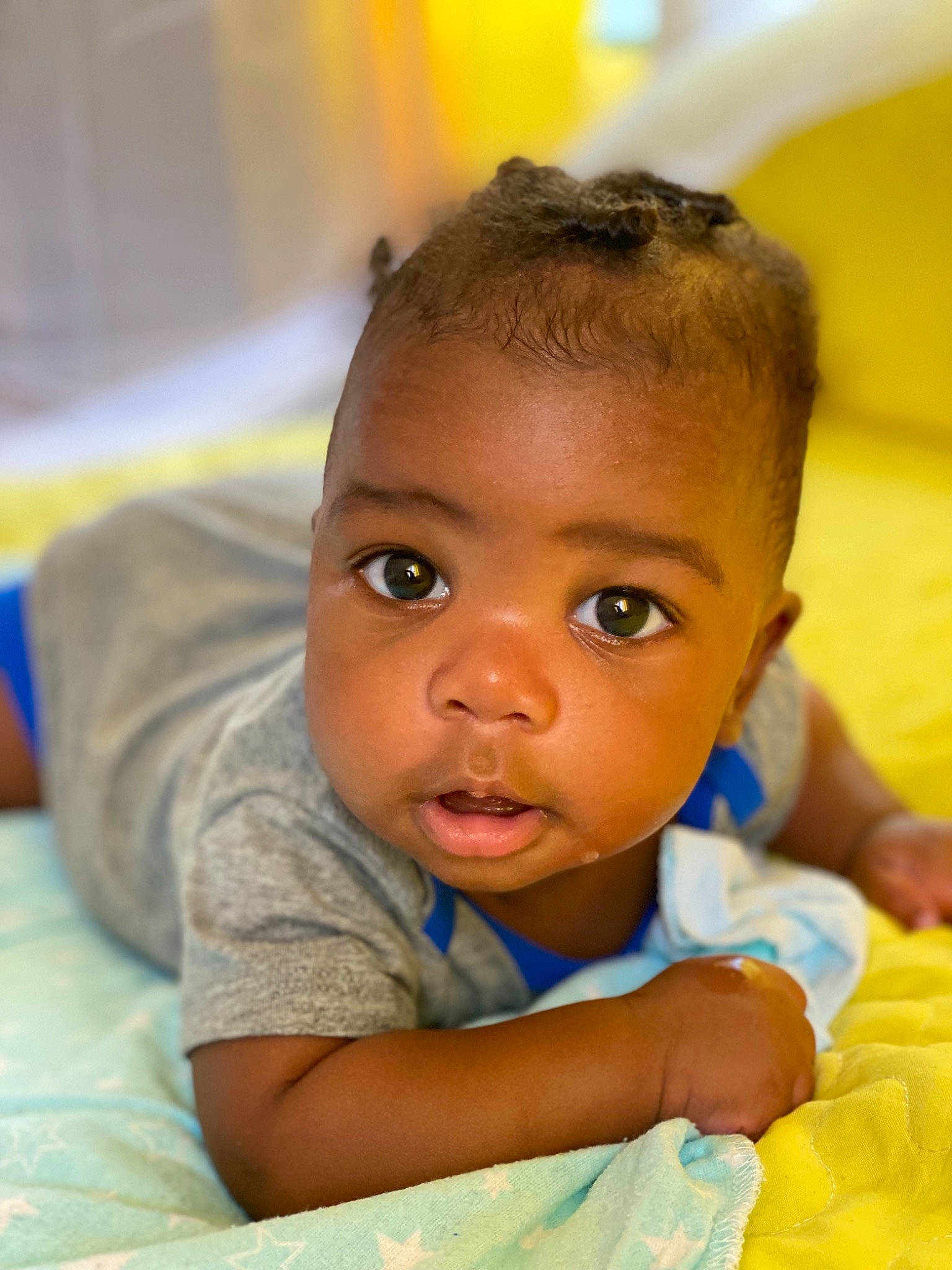 Ayaan is registered to the contest to win money with this photo: arm, baby, cheek, ear, eye, eyebrow, eyelash, forehead, gesture, happy, head, human_body, iris, neck, nose, person, skin, smile, t_shirt, toddler