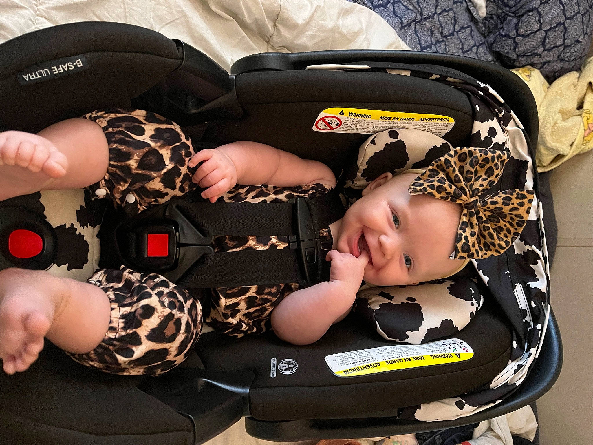 Stella James is registered to the contest to win money with this photo: auto_part, baby, baby_carriage, baby_products, baby_toddler_clothing, bag, car_seat, child, comfort, fashion_accessory, flash_photography, gesture, hairstyle, headwear, nail, person, personal_protective_equipment, product, sitting, sleeve